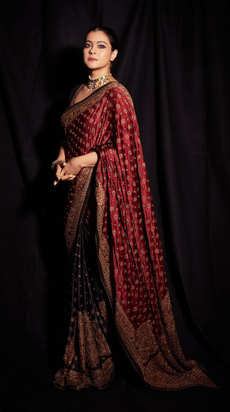 KAJOL IN A BLACK & BURGUNDY EMBROIDERED SAREE WITH STITCHED BLOUSE